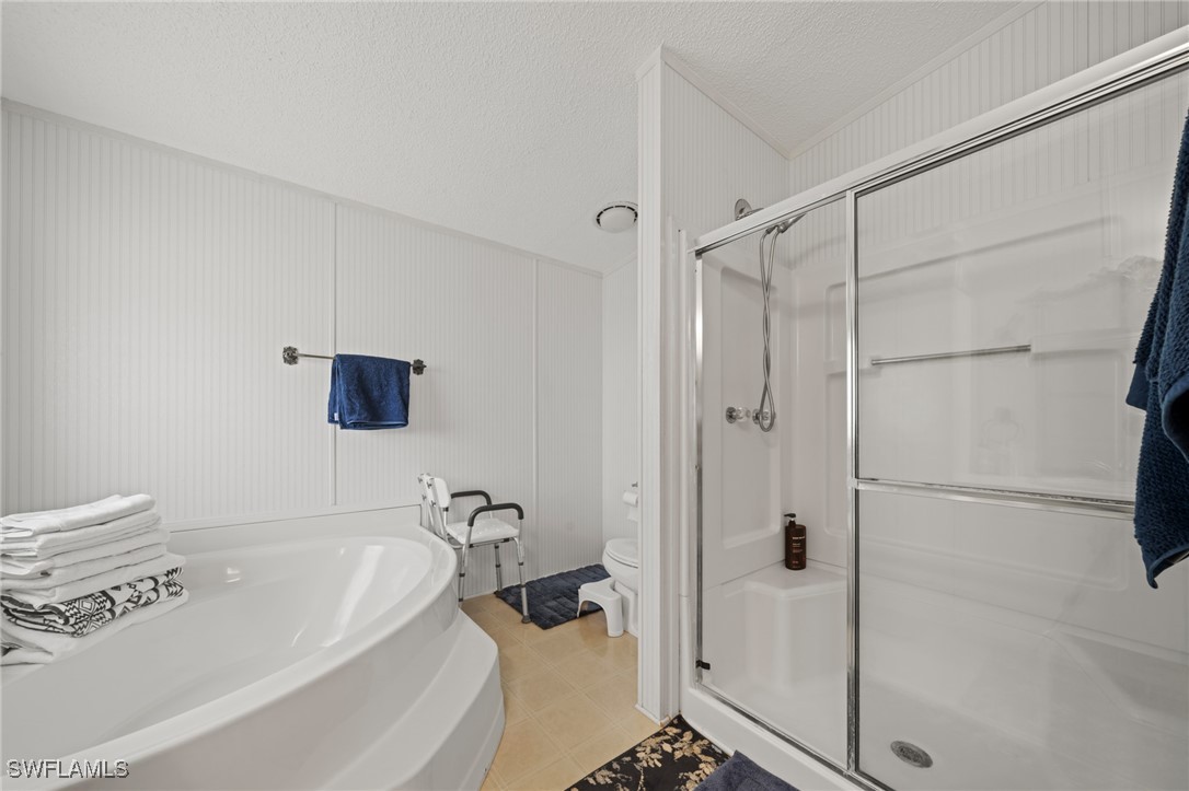 919 Manatee Road Naples, FL 34114 - Photo 21 of 32 a bathroom with a bathtub and a shower