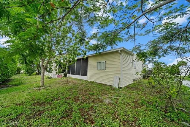 a backyard of a house with table and chairs