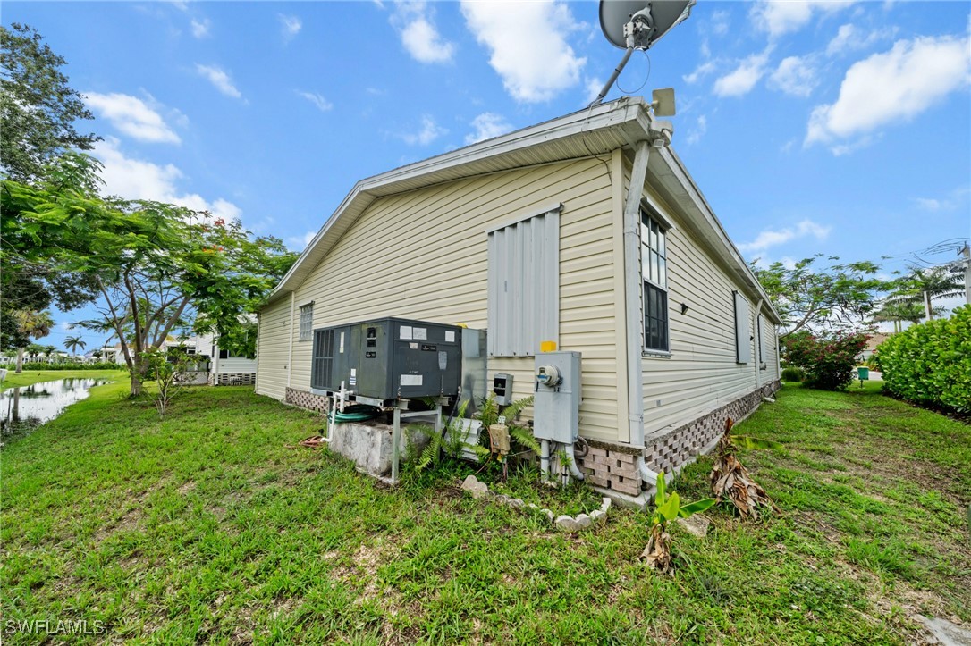 919 Manatee Road Naples, FL 34114 - Photo 29 of 32 a backyard of a house with table and chairs