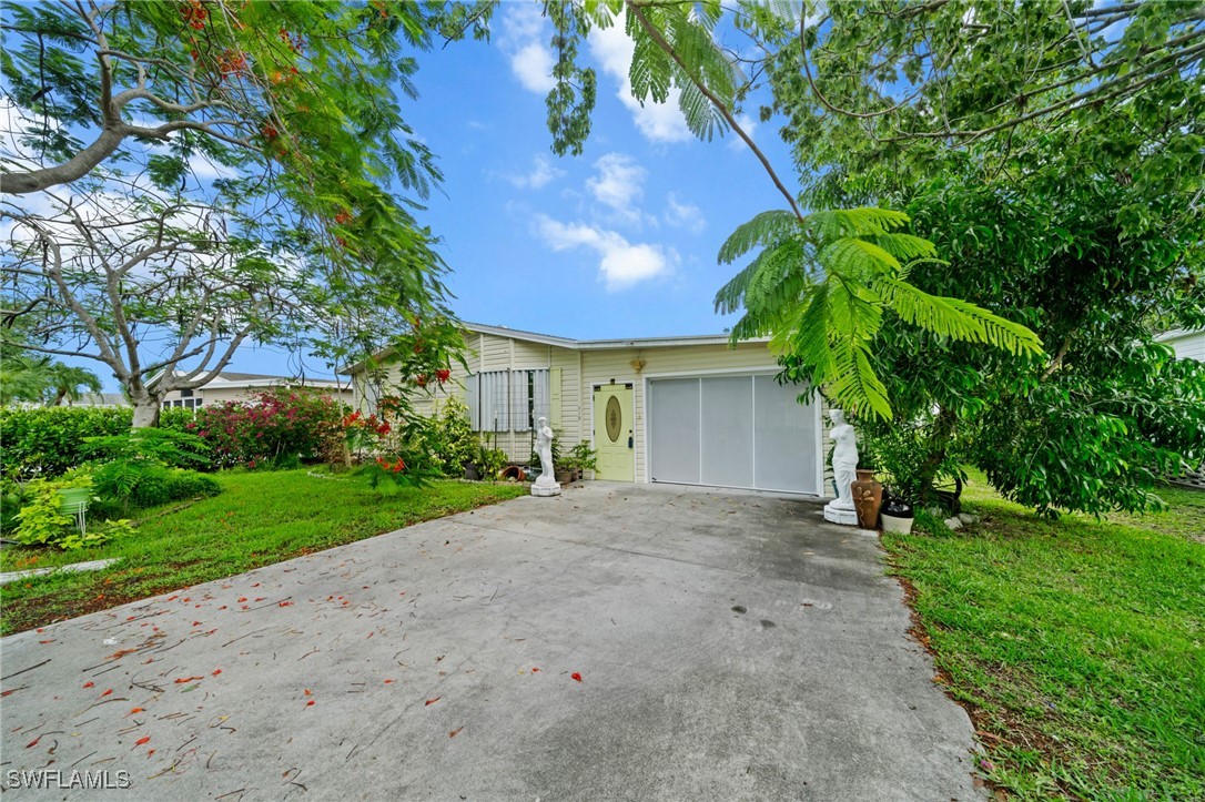 919 Manatee Road Naples, FL 34114 - Photo 30 of 32 a view of a house with a yard and potted plants