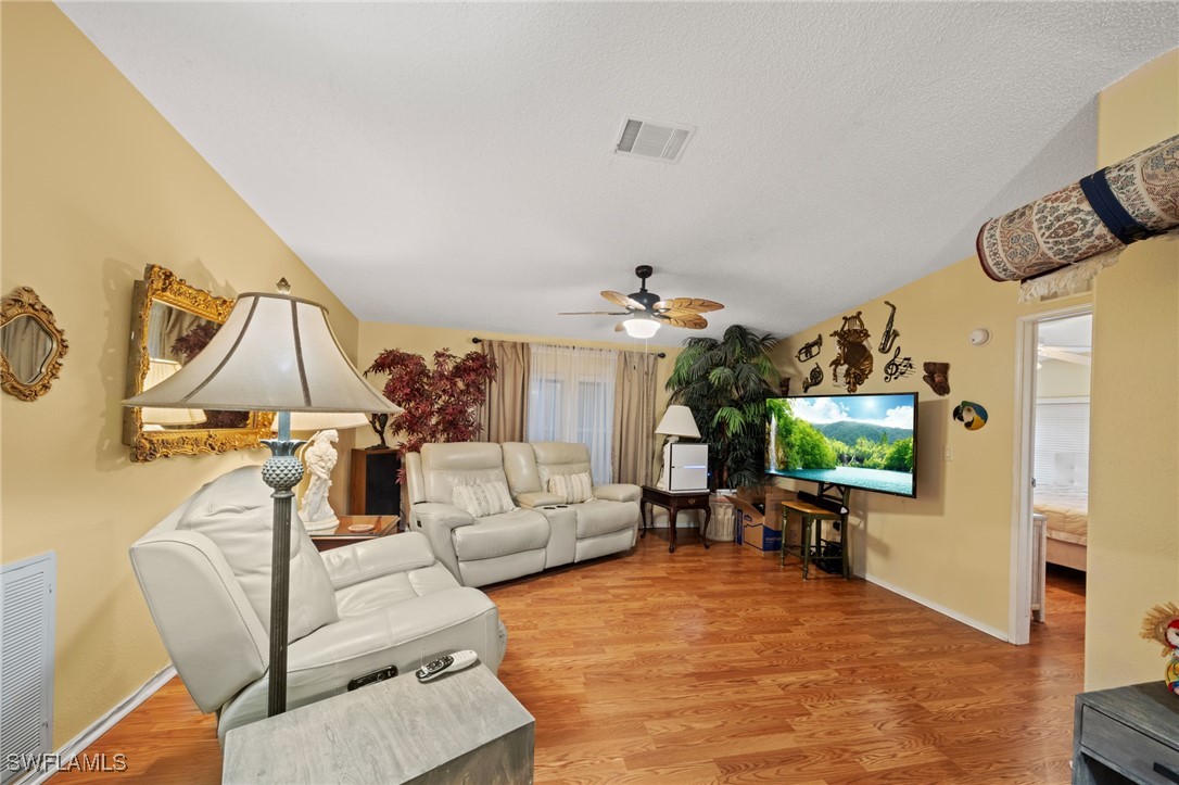 919 Manatee Road Naples, FL 34114 - Photo 5 of 32 a living room with furniture and a flat screen tv
