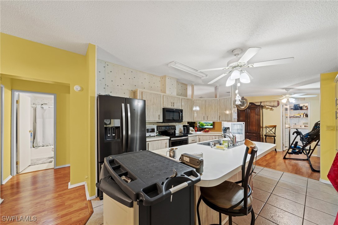 919 Manatee Road Naples, FL 34114 - Photo 6 of 32 a view of a dining room with furniture and wooden floor