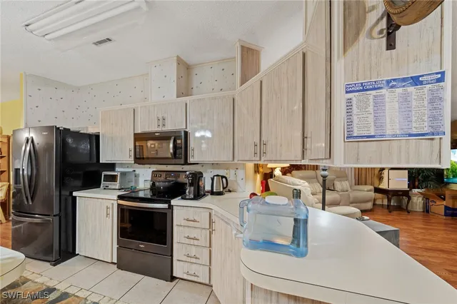 a kitchen with a sink a stove a refrigerator and cabinets