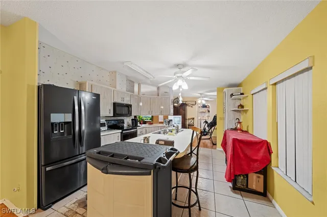 a view of a kitchen with refrigerator and dining table