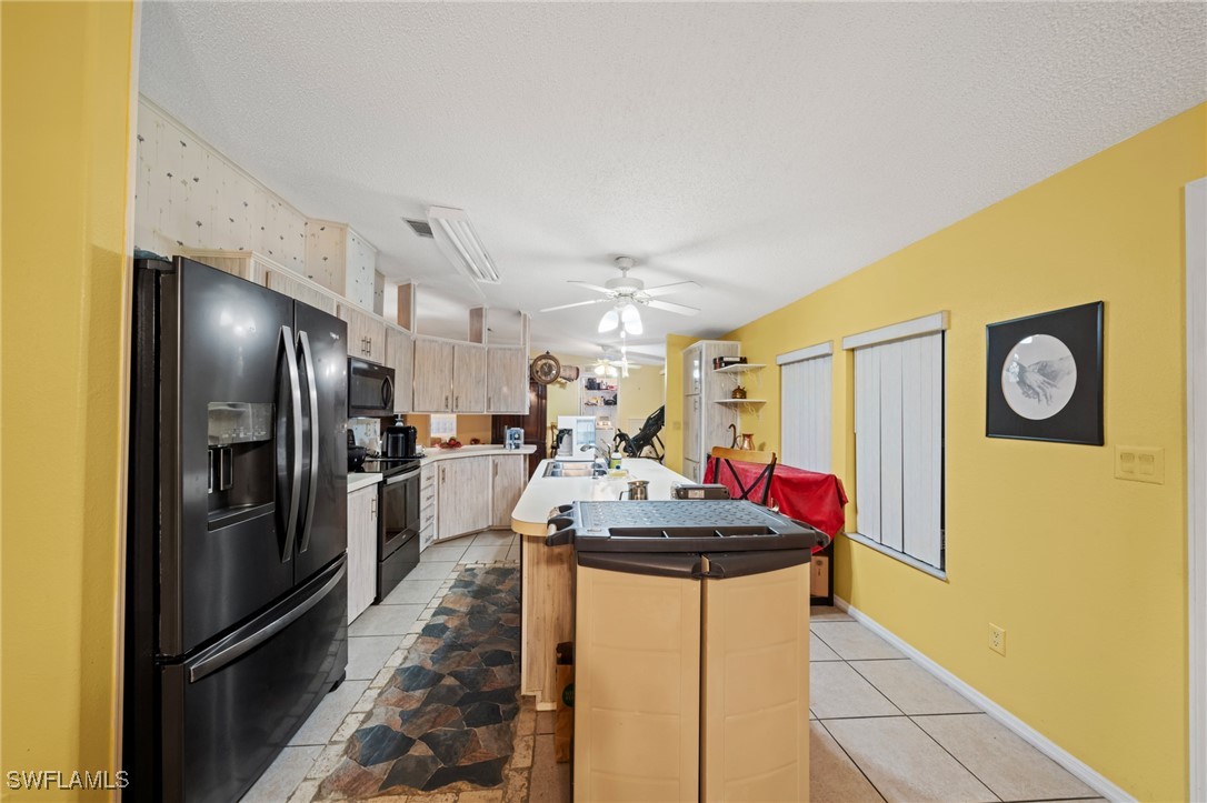 919 Manatee Road Naples, FL 34114 - Photo 10 of 32 a kitchen with stainless steel appliances granite countertop a refrigerator and a sink
