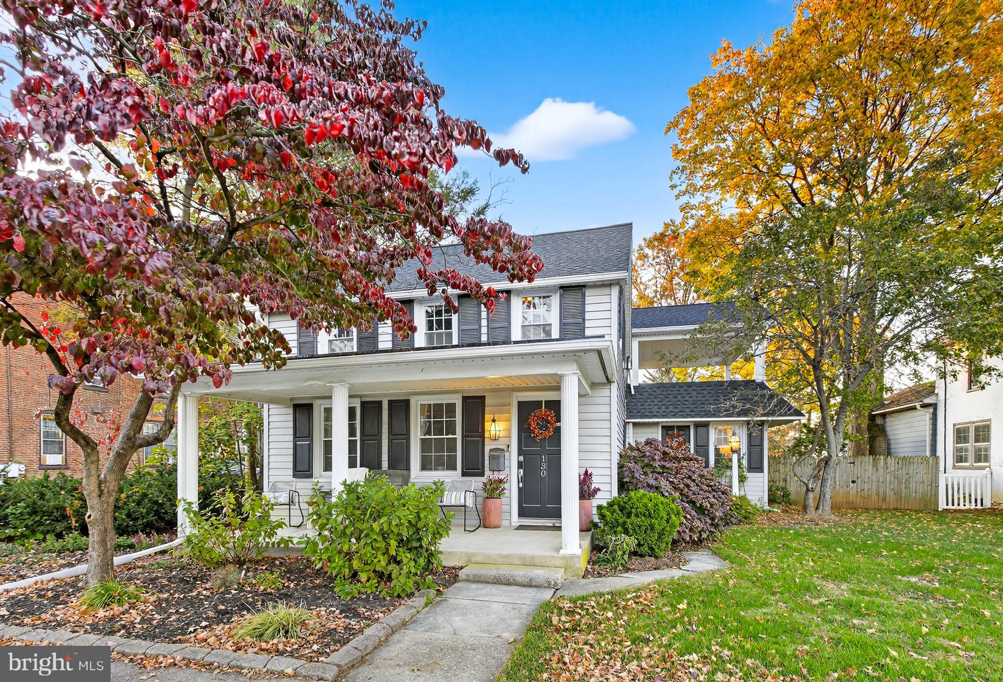 front view of a brick house with a yard