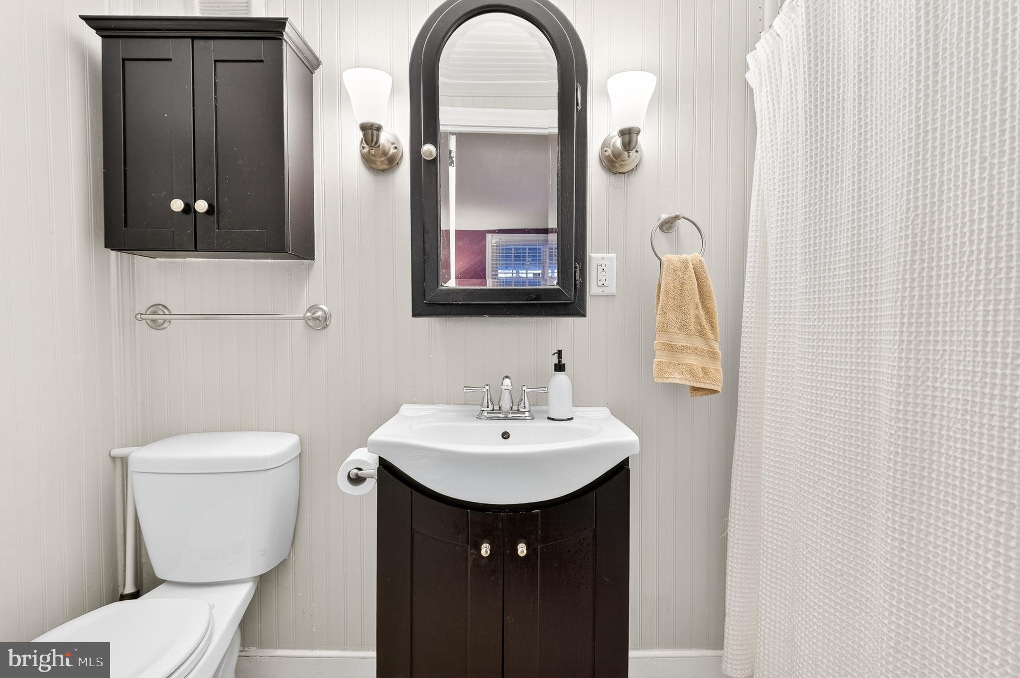 130 East High Street Manheim, PA 17545 - Photo 12 of 34 a bathroom with a toilet sink and mirror