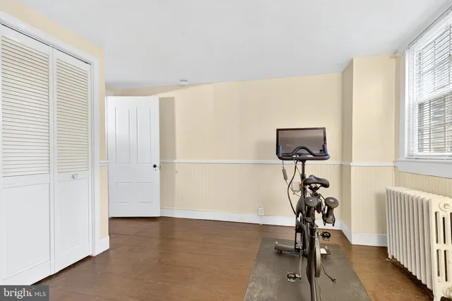 a view of a room with gym equipment and a window