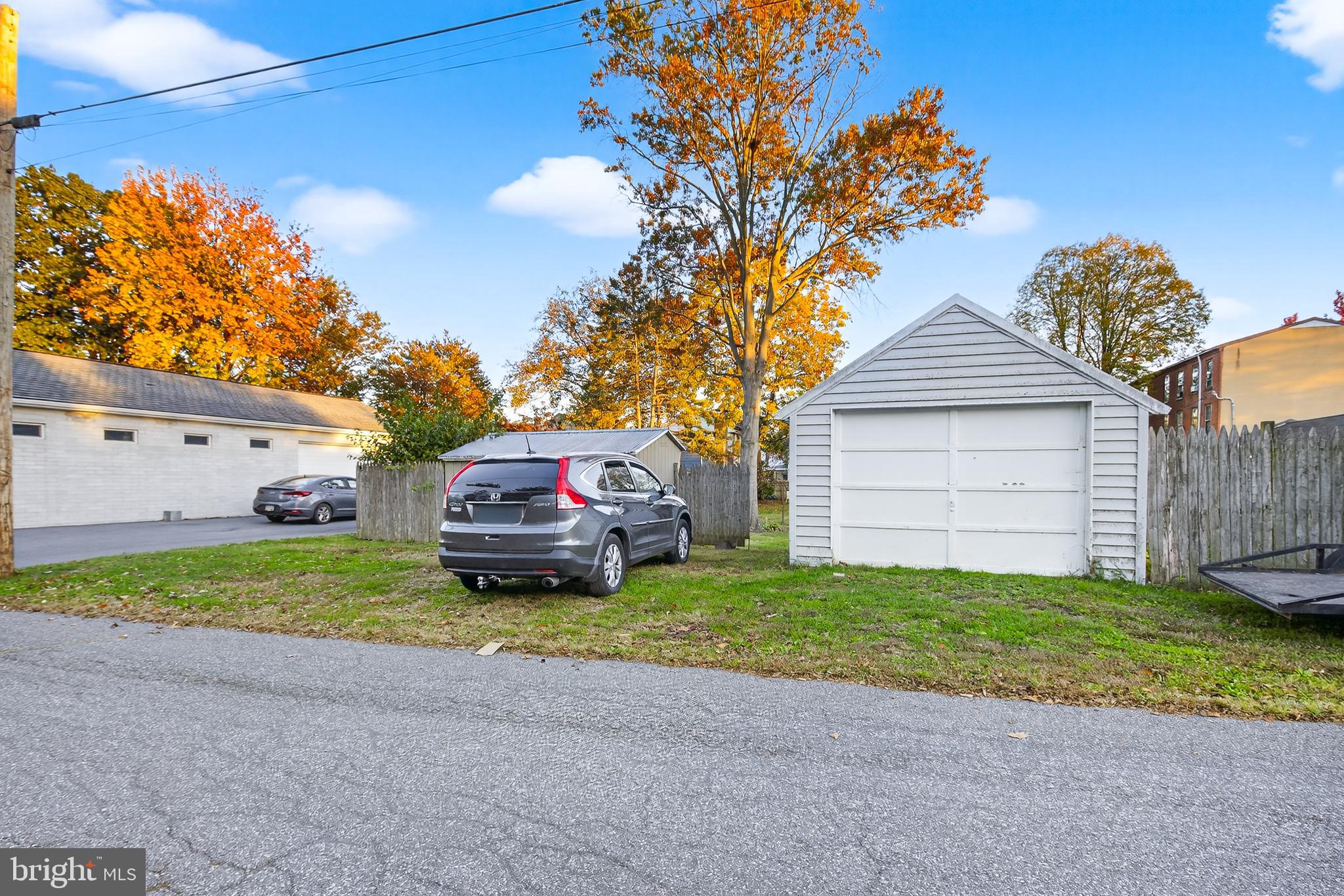 130 East High Street Manheim, PA 17545 - Photo 28 of 34 a front view of a house with a garden and trees