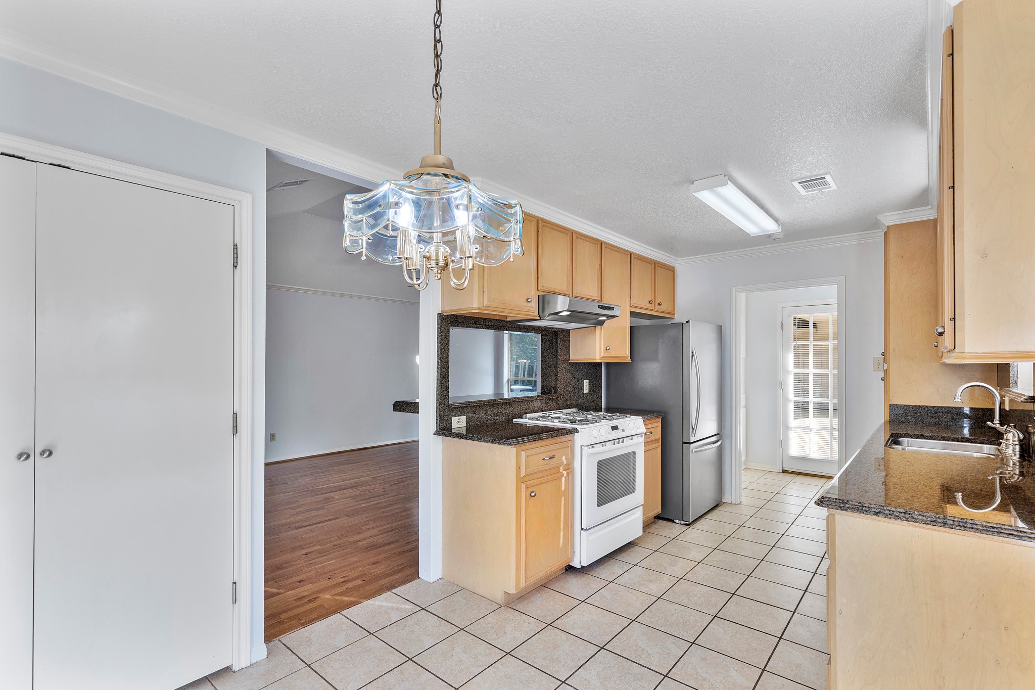 8018 Holiday Lane Houston, TX 77075 - Photo 16 of 42 a kitchen with stainless steel appliances granite countertop a stove and a refrigerator
