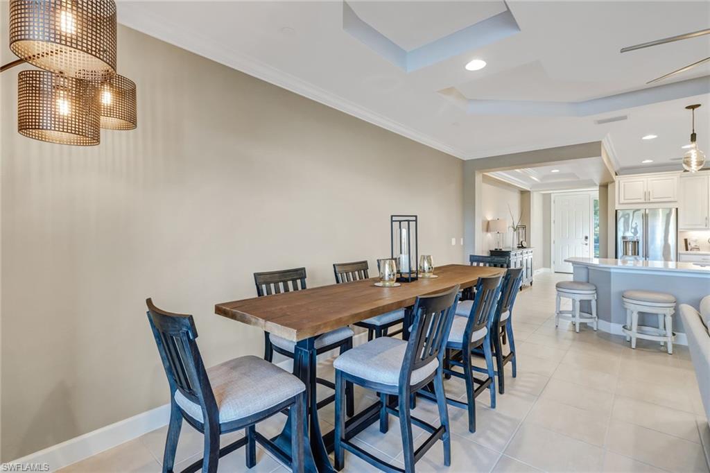 9653 Montelanico Loop, Unit 102 Naples, FL 34119 - Photo 12 of 26 a view of a dining room with furniture
