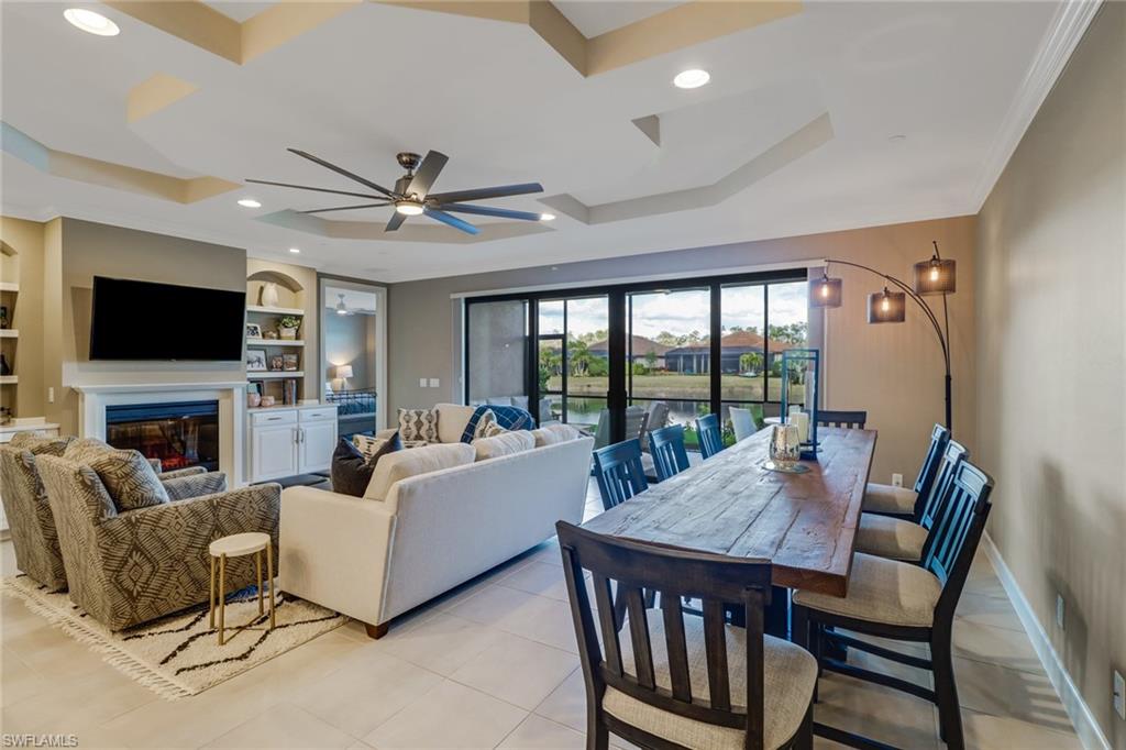 9653 Montelanico Loop, Unit 102 Naples, FL 34119 - Photo 13 of 26 a living room with fireplace furniture and a flat screen tv