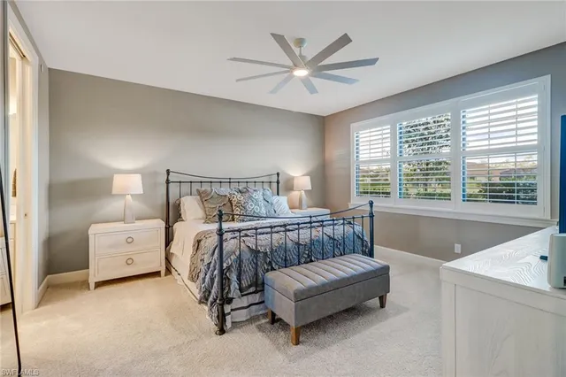 a bedroom with a bed and a large window