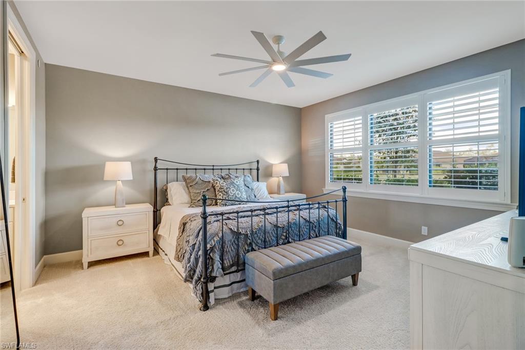9653 Montelanico Loop, Unit 102 Naples, FL 34119 - Photo 14 of 26 a bedroom with a bed and a large window