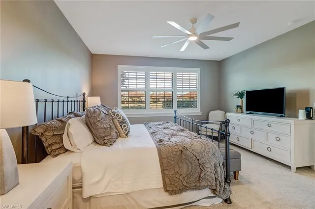 a bedroom with furniture and a flat screen tv