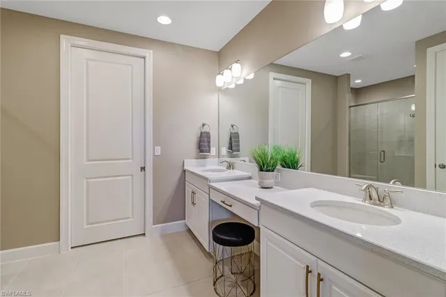 a bathroom with a granite countertop sink a large mirror and a shower