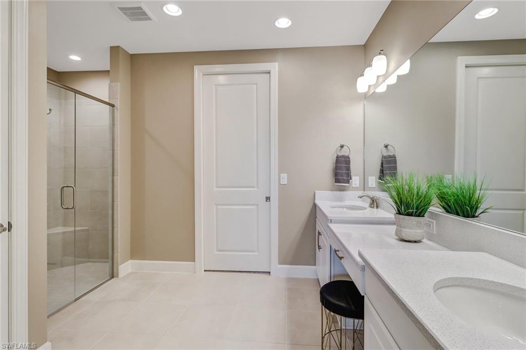 9653 Montelanico Loop, Unit 102 Naples, FL 34119 - Photo 17 of 26 a room with a sink and a mirror