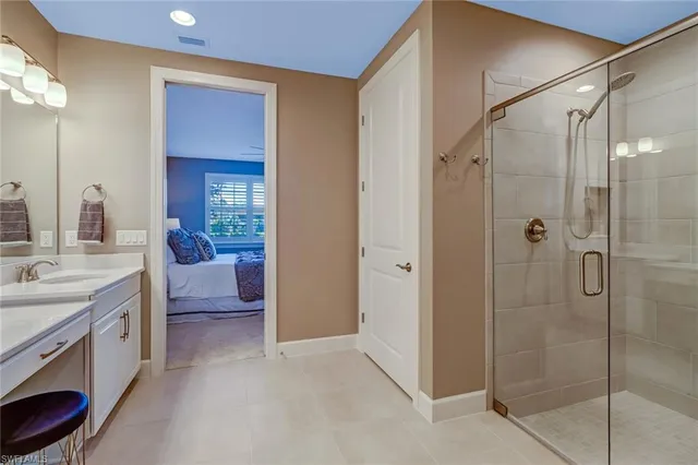 a bathroom with a shower sink and mirror