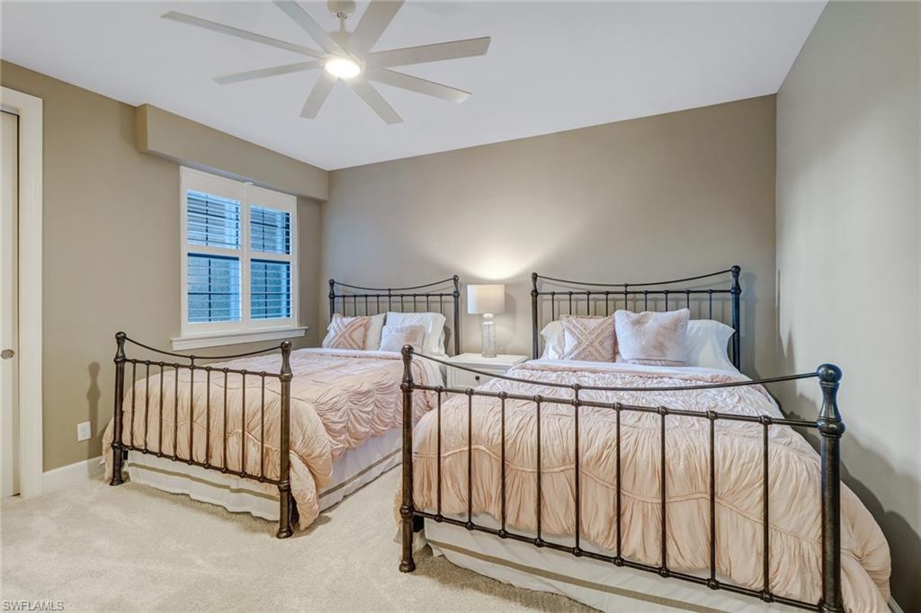 9653 Montelanico Loop, Unit 102 Naples, FL 34119 - Photo 19 of 26 a bedroom with a bed and window