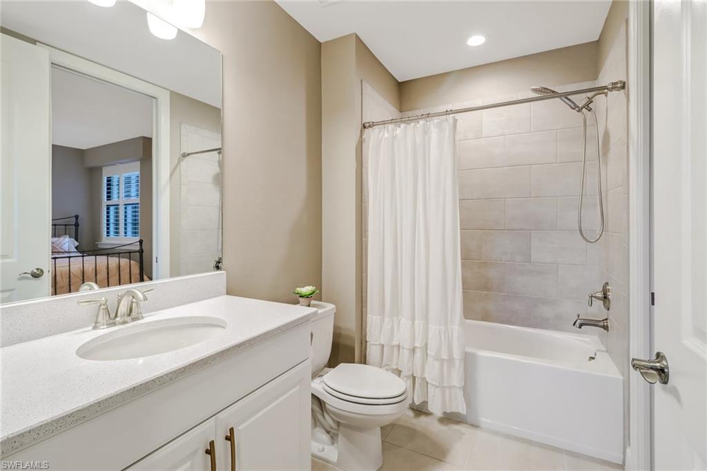 9653 Montelanico Loop, Unit 102 Naples, FL 34119 - Photo 20 of 26 a bathroom with a sink toilet and shower