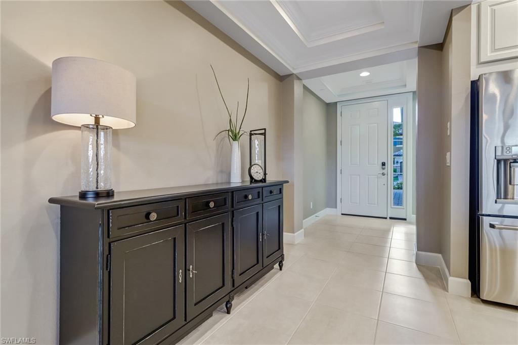 9653 Montelanico Loop, Unit 102 Naples, FL 34119 - Photo 2 of 26 a kitchen with stainless steel appliances granite countertop a sink and a refrigerator