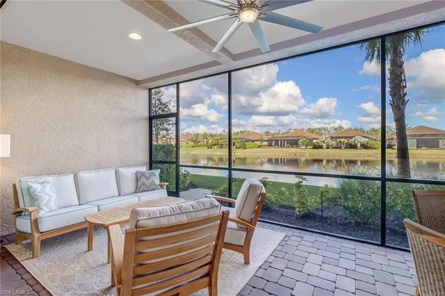a living room with furniture and a floor to ceiling window