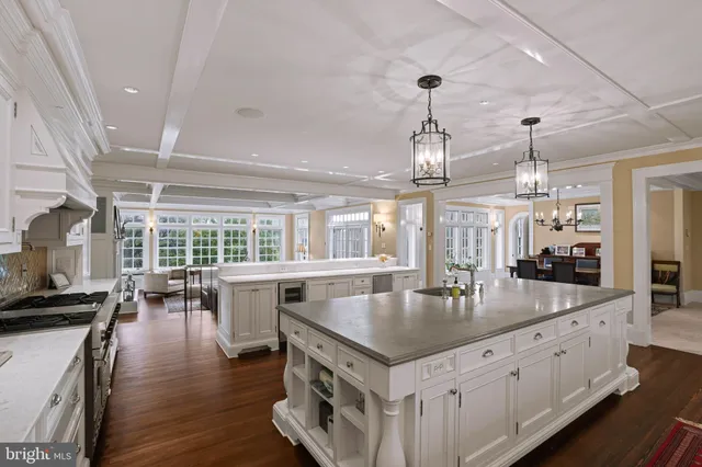 a large kitchen with a large counter top appliances and cabinets