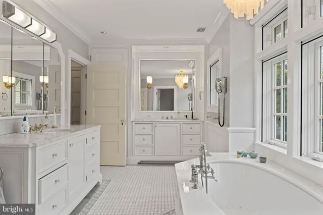 a front view of a house with a garden and trees