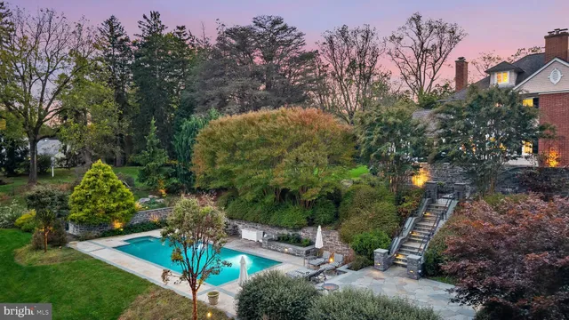 a backyard of a house with lots of green space and fountain