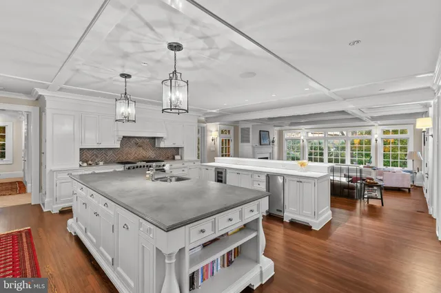 a kitchen with a stove and wooden floor