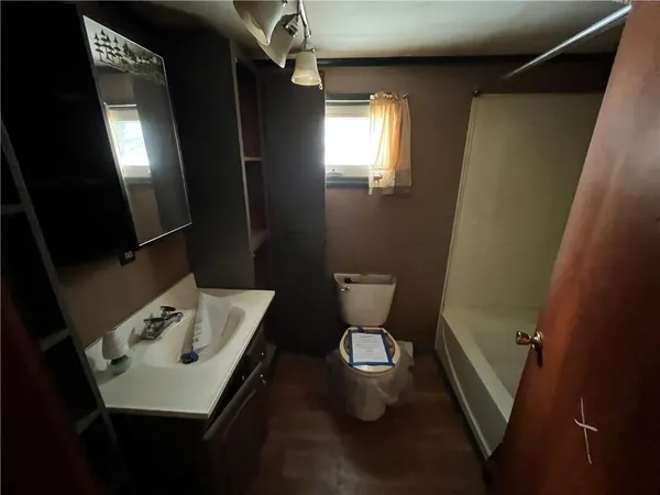 a bathroom with a sink a toilet a mirror and vanity