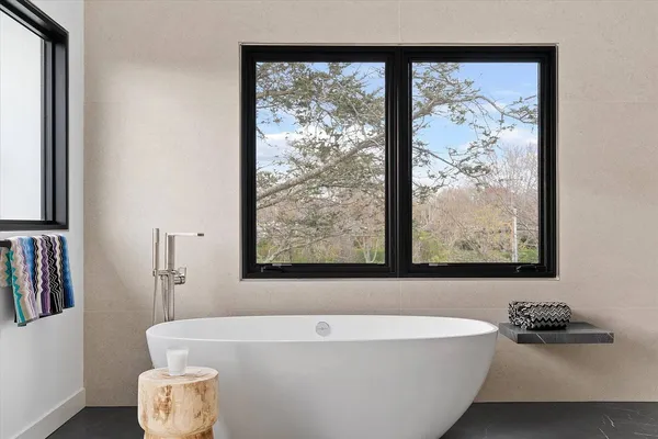 a bathroom with a bathtub and a window