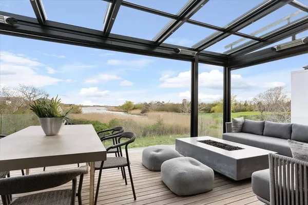 a living room with furniture and a floor to ceiling window