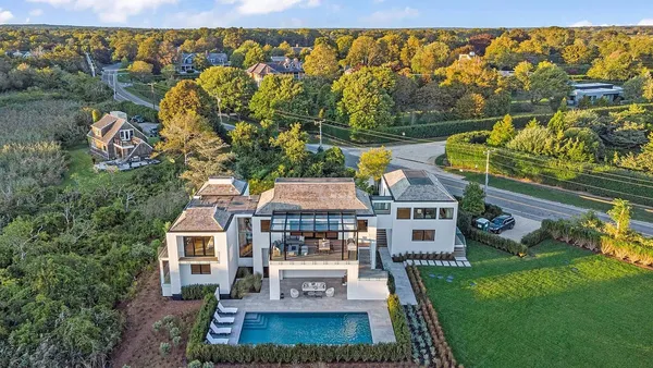 an aerial view of a house with a garden and swimming pool