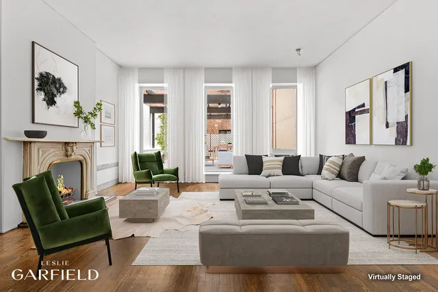 a living room with fireplace furniture and a large window