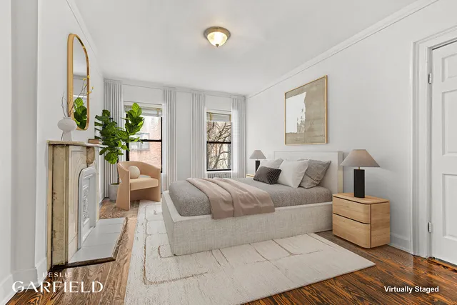 a living room with a couch and a potted plant