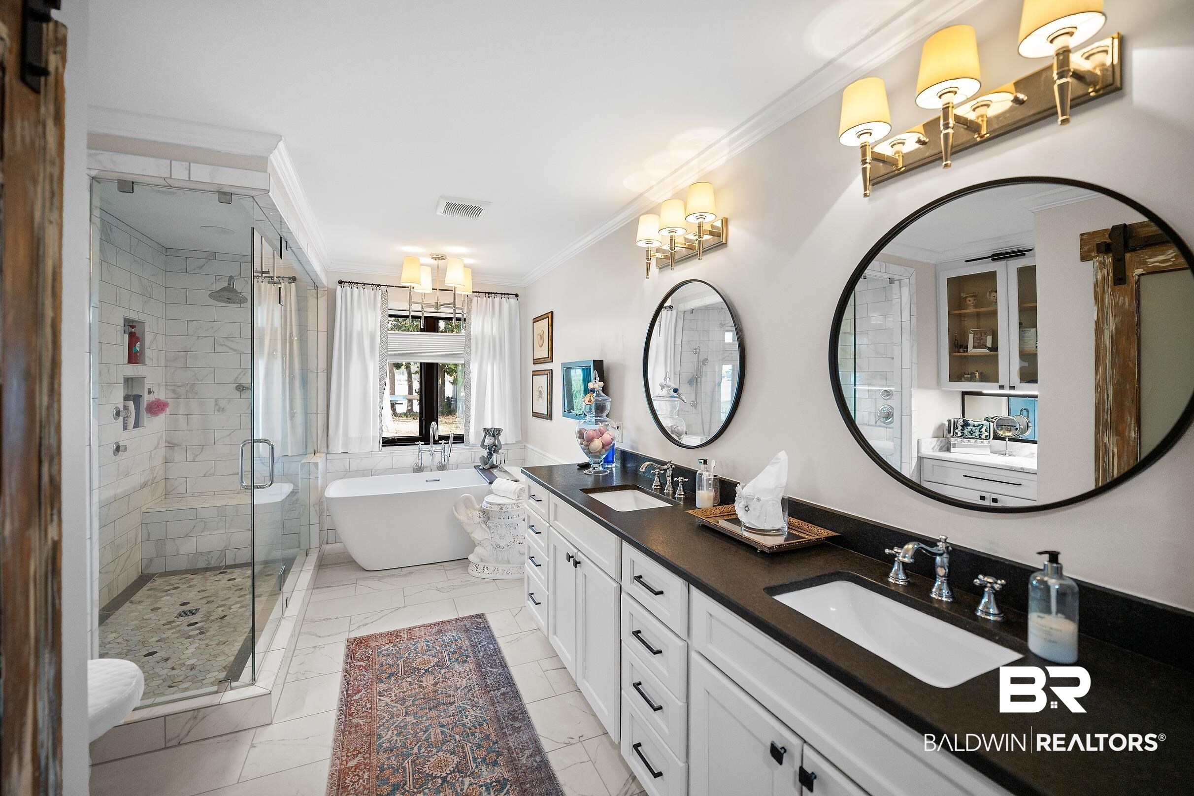 8490 Bay View Drive Foley, AL 36535 - Photo 39 of 67 Full bathroom featuring a freestanding tub, crown molding, double vanity, a stall shower, and light marble finish flooring