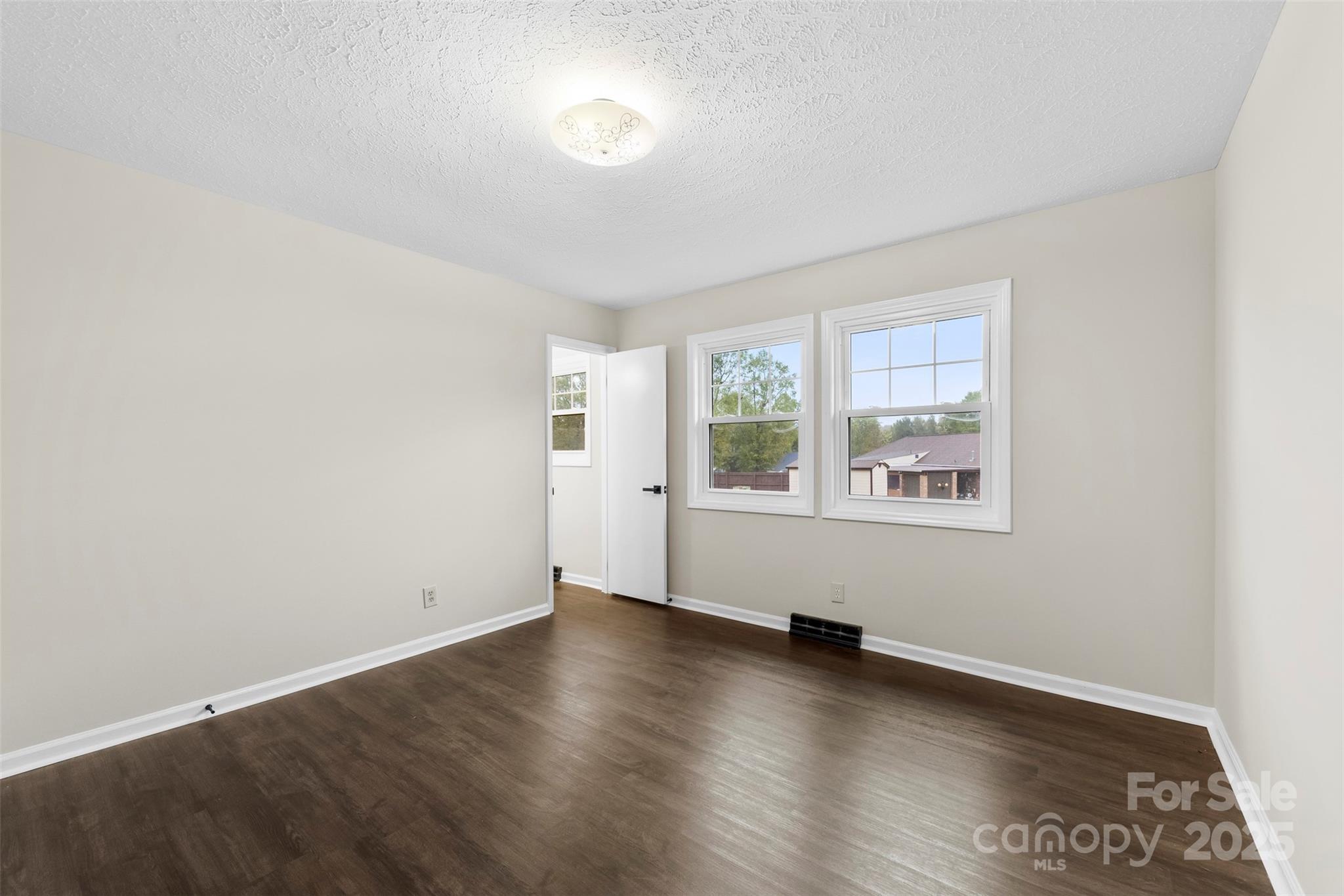 404 James Love School Road Shelby, NC 28152 - Photo 16 of 25 an empty room with wooden floor and windows
