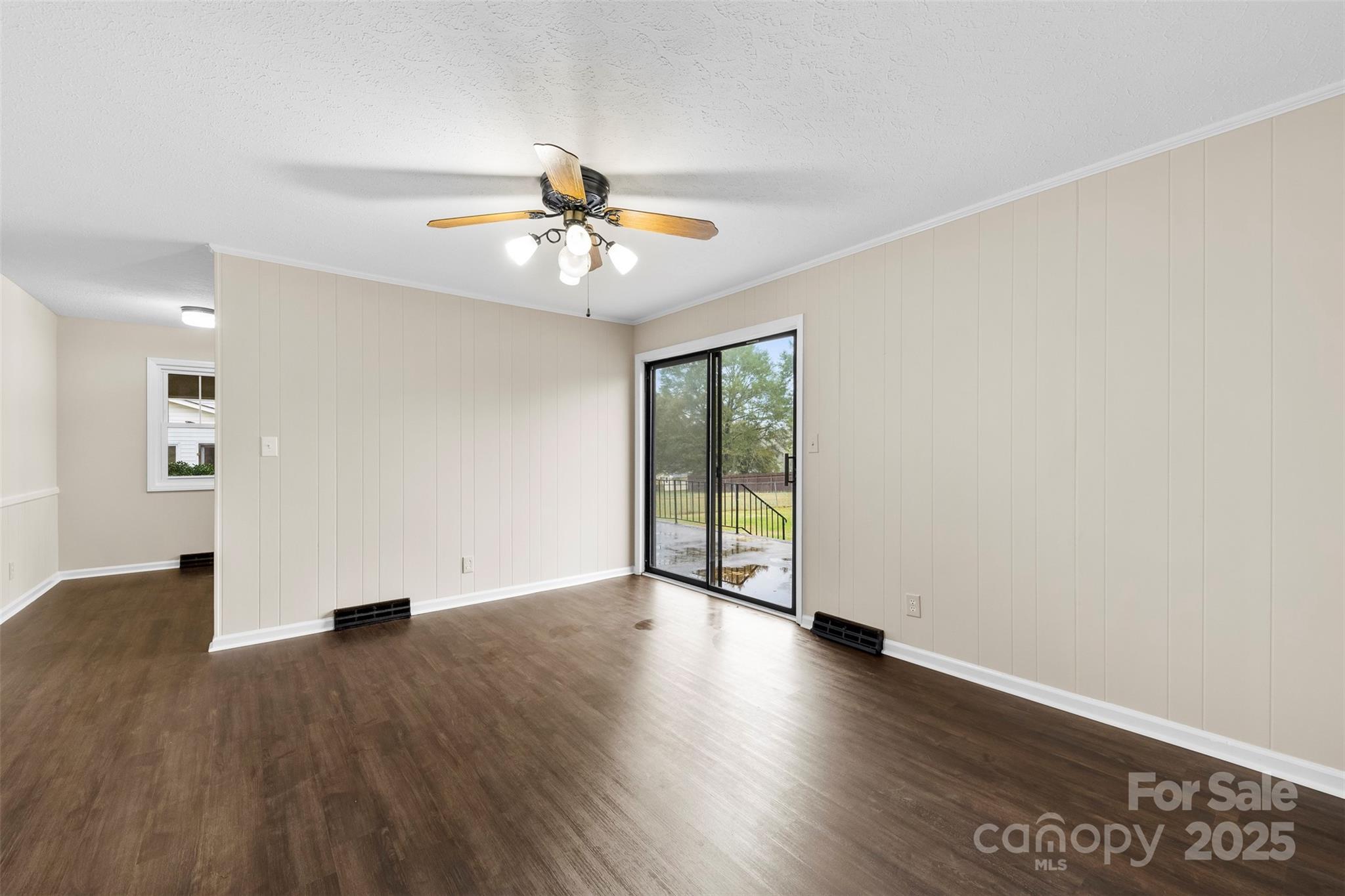 404 James Love School Road Shelby, NC 28152 - Photo 5 of 25 a view of an empty room with window and wooden floor