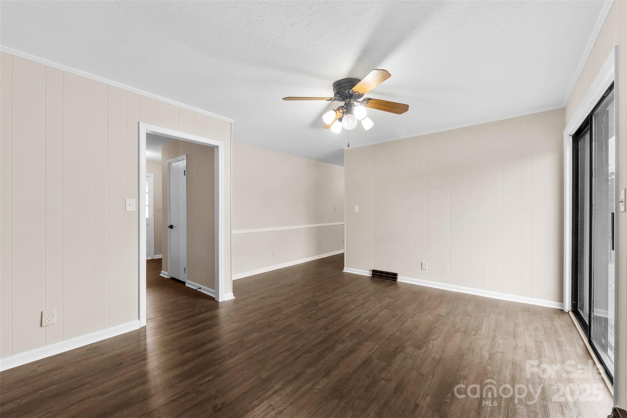 404 James Love School Road Shelby, NC 28152 - Photo 8 of 25 an empty room with wooden floor chandelier fan and windows