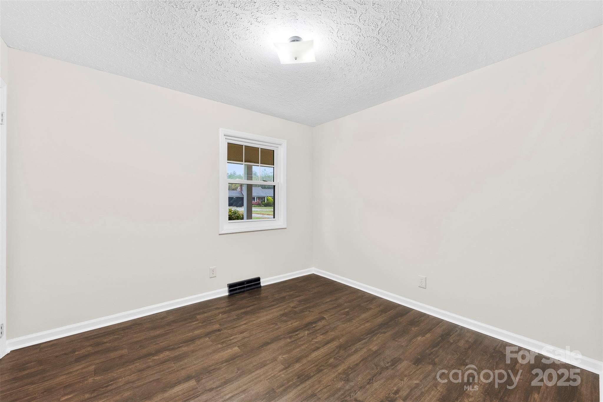 404 James Love School Road Shelby, NC 28152 - Photo 10 of 25 an empty room with wooden floor and windows