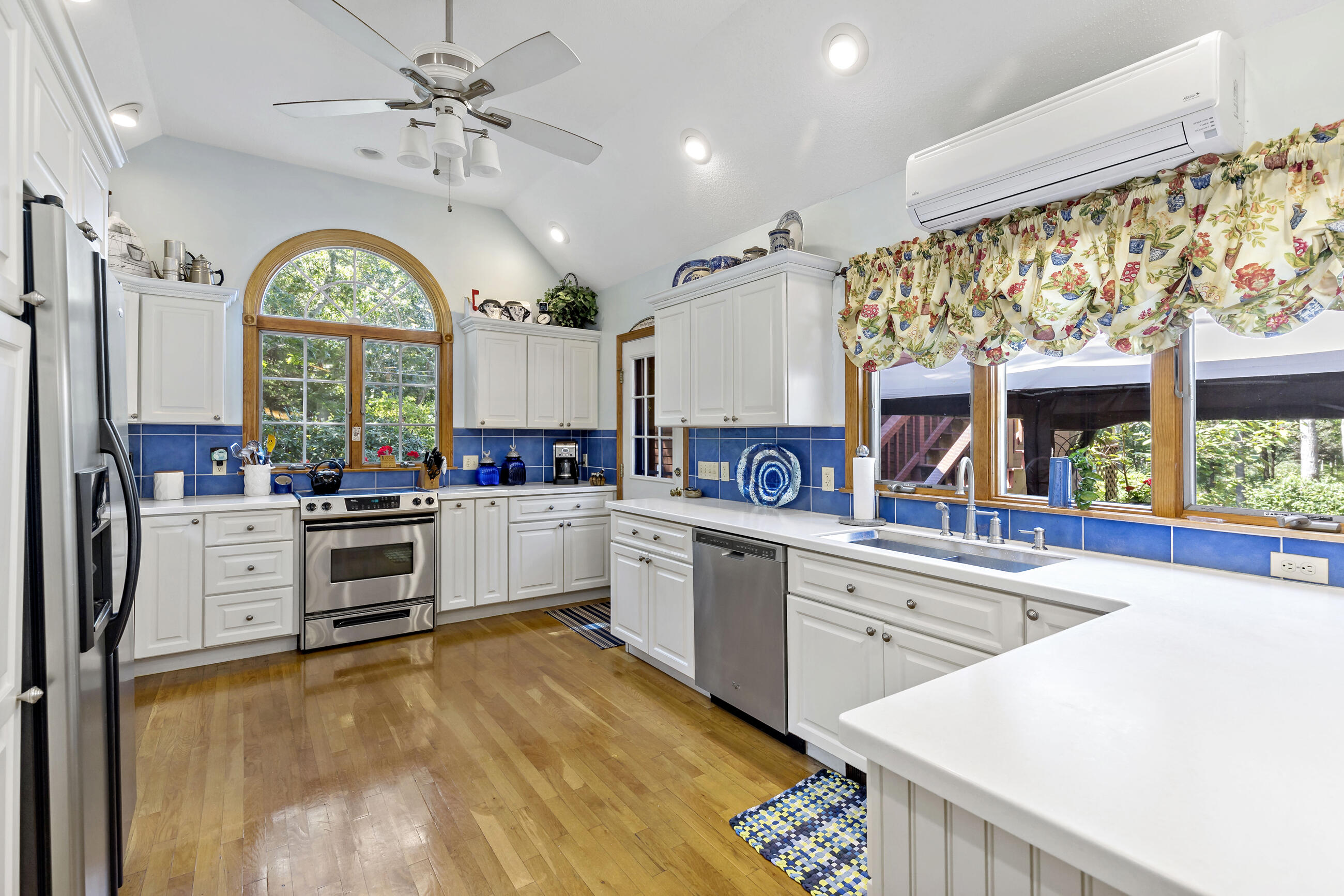 60 Turnip Field Road Eastham, MA 02642 - Photo 12 of 57 a large white kitchen with a large window a sink and stainless steel appliances