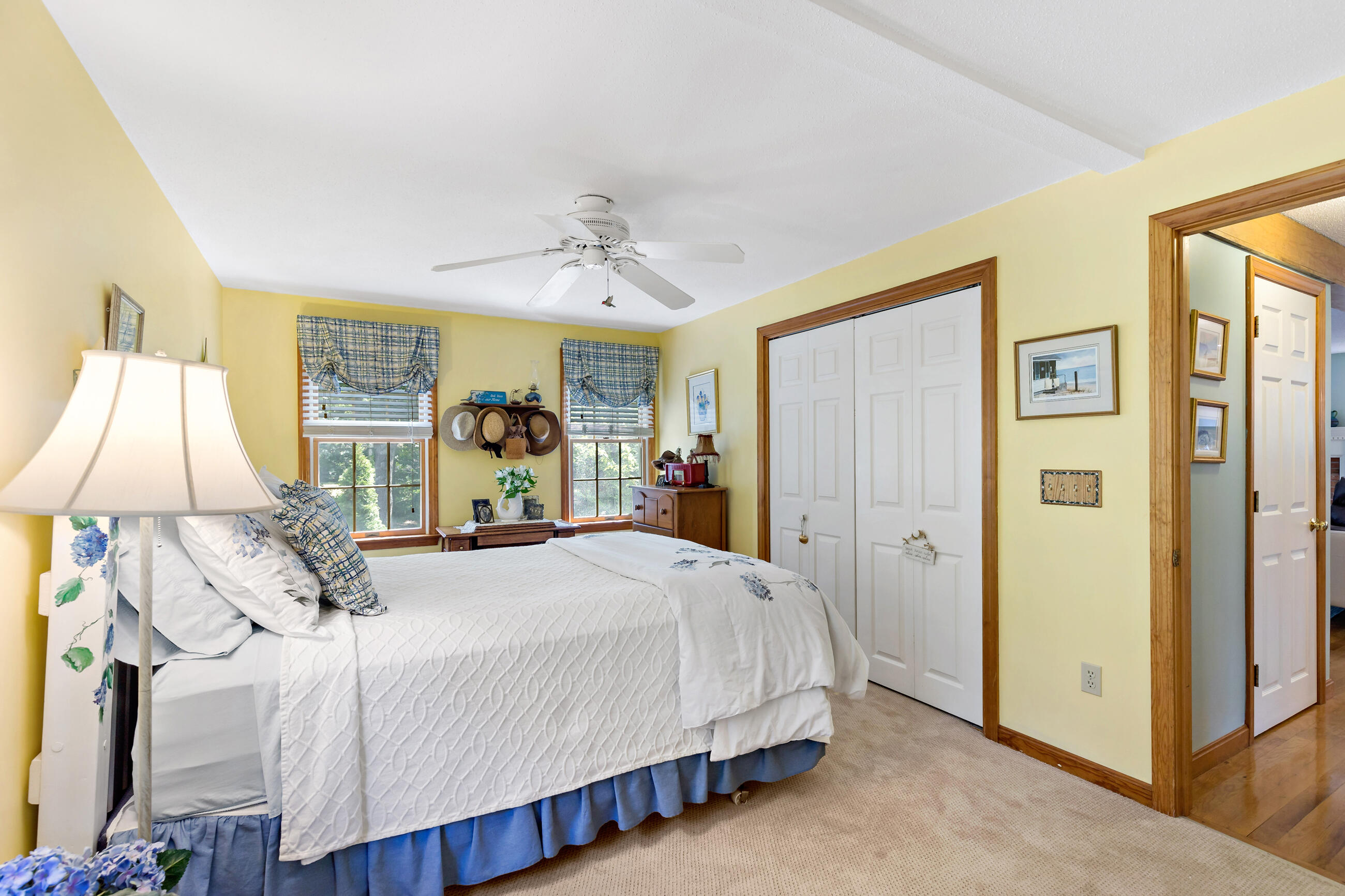 60 Turnip Field Road Eastham, MA 02642 - Photo 28 of 57 a spacious bedroom with a bed and a lamp
