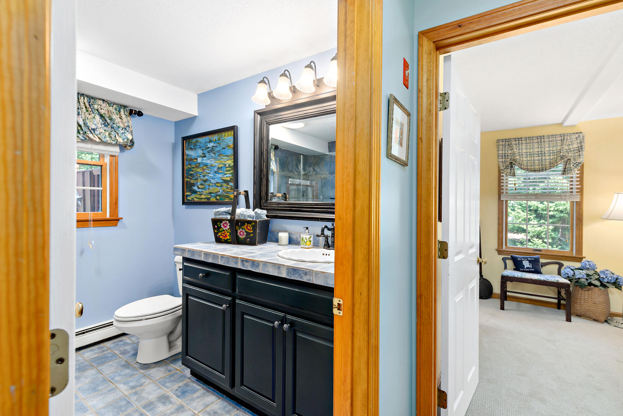60 Turnip Field Road Eastham, MA 02642 - Photo 30 of 57 a bathroom with a granite countertop sink a toilet and a mirror