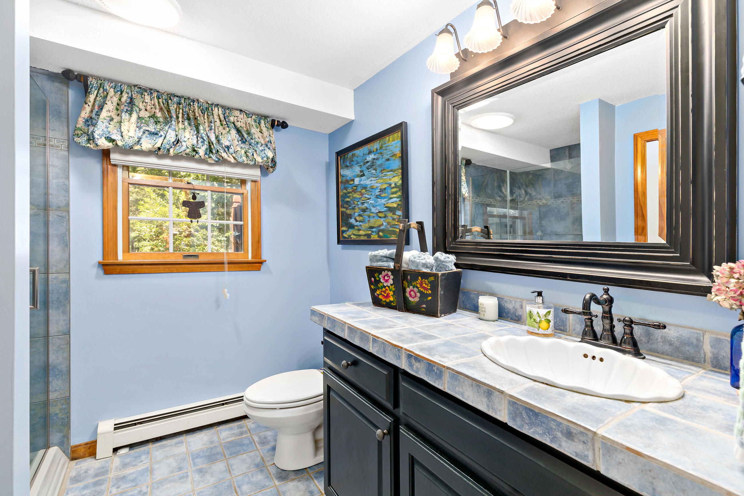 60 Turnip Field Road Eastham, MA 02642 - Photo 31 of 57 a bathroom with a granite countertop toilet a sink and a mirror