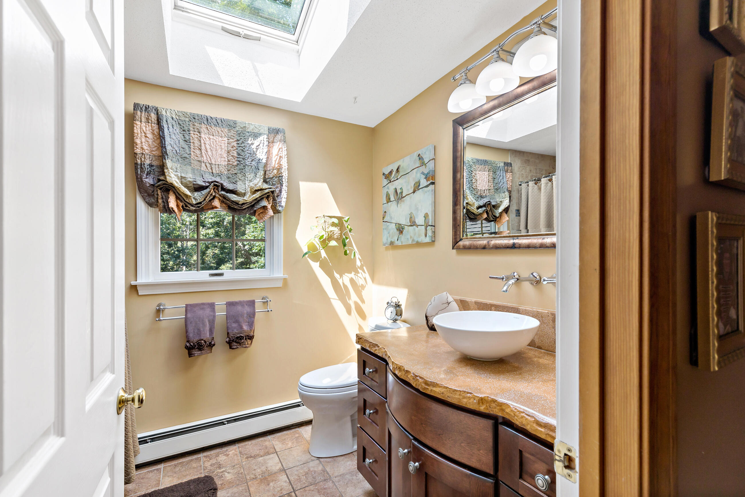 60 Turnip Field Road Eastham, MA 02642 - Photo 35 of 57 a bathroom with a granite countertop sink toilet and a mirror