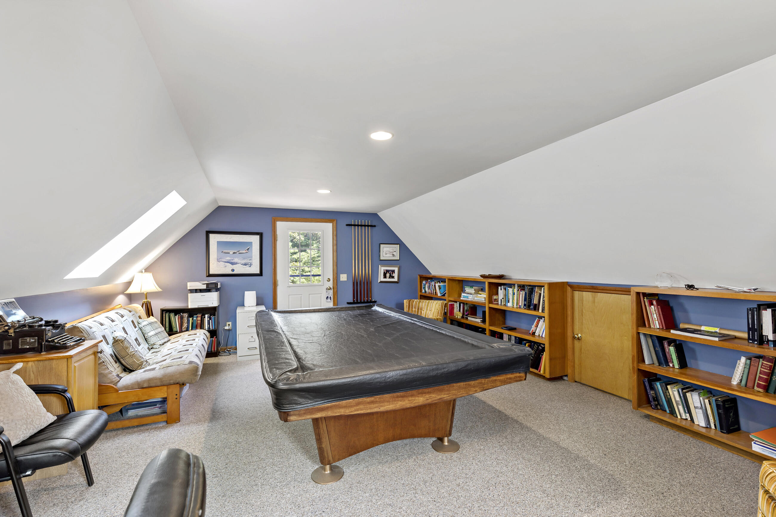 60 Turnip Field Road Eastham, MA 02642 - Photo 41 of 57 a living room with furniture a rug and a book shelf