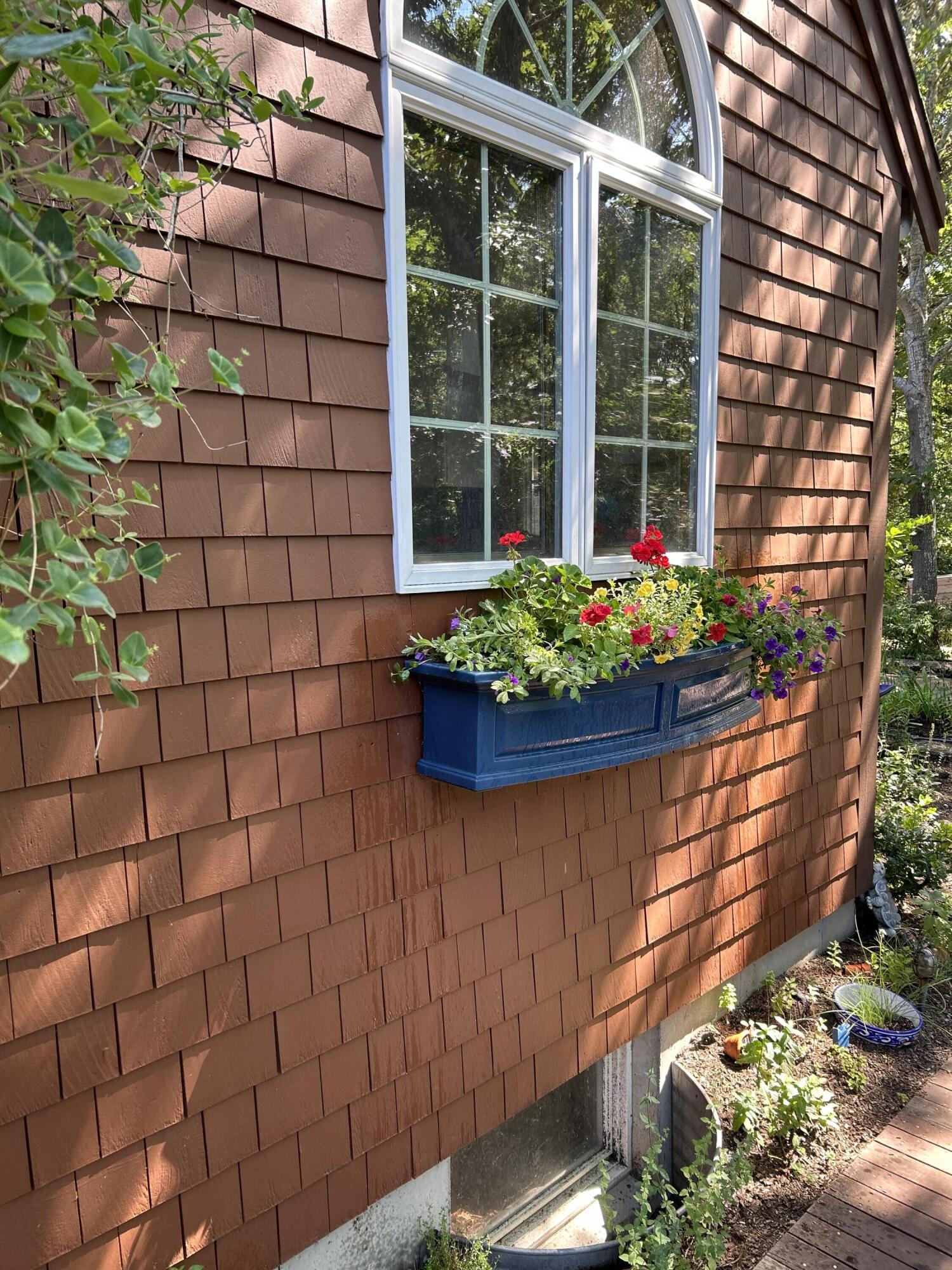 60 Turnip Field Road Eastham, MA 02642 - Photo 46 of 57 a flower garden in front of a building