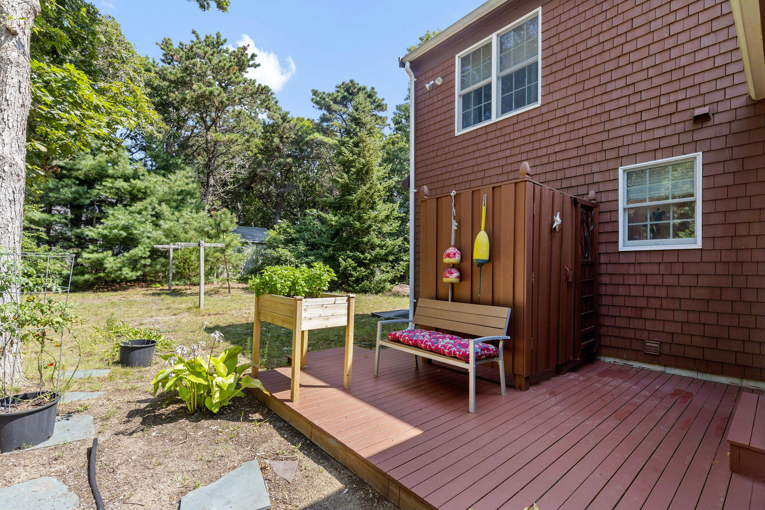60 Turnip Field Road Eastham, MA 02642 - Photo 9 of 57 a wooden bench sitting in front of a building