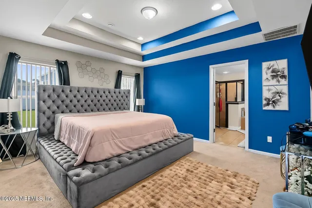 a bedroom with a large bed and a couch